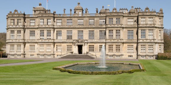 Grand Longleat House in Wiltshire, with symmetrical gardens and fountain in front, Near Brokerswood Holiday Park.