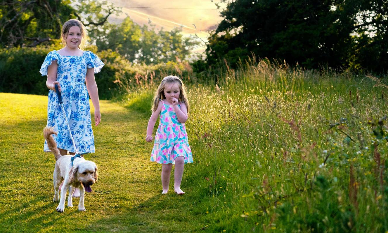 Devon Hills Children Walking A Small Dog