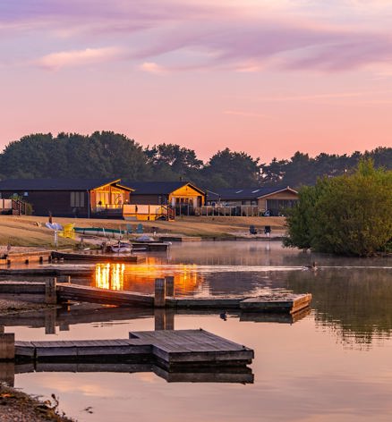 Delamere Lodges And Lake At Sunrise