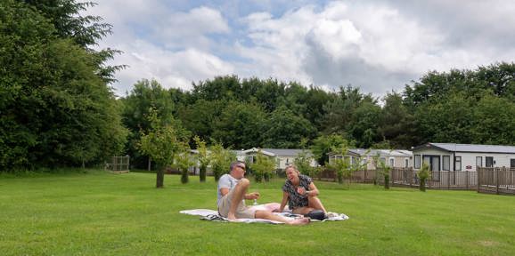 Dartmoor View Couple Laughing On Grass
