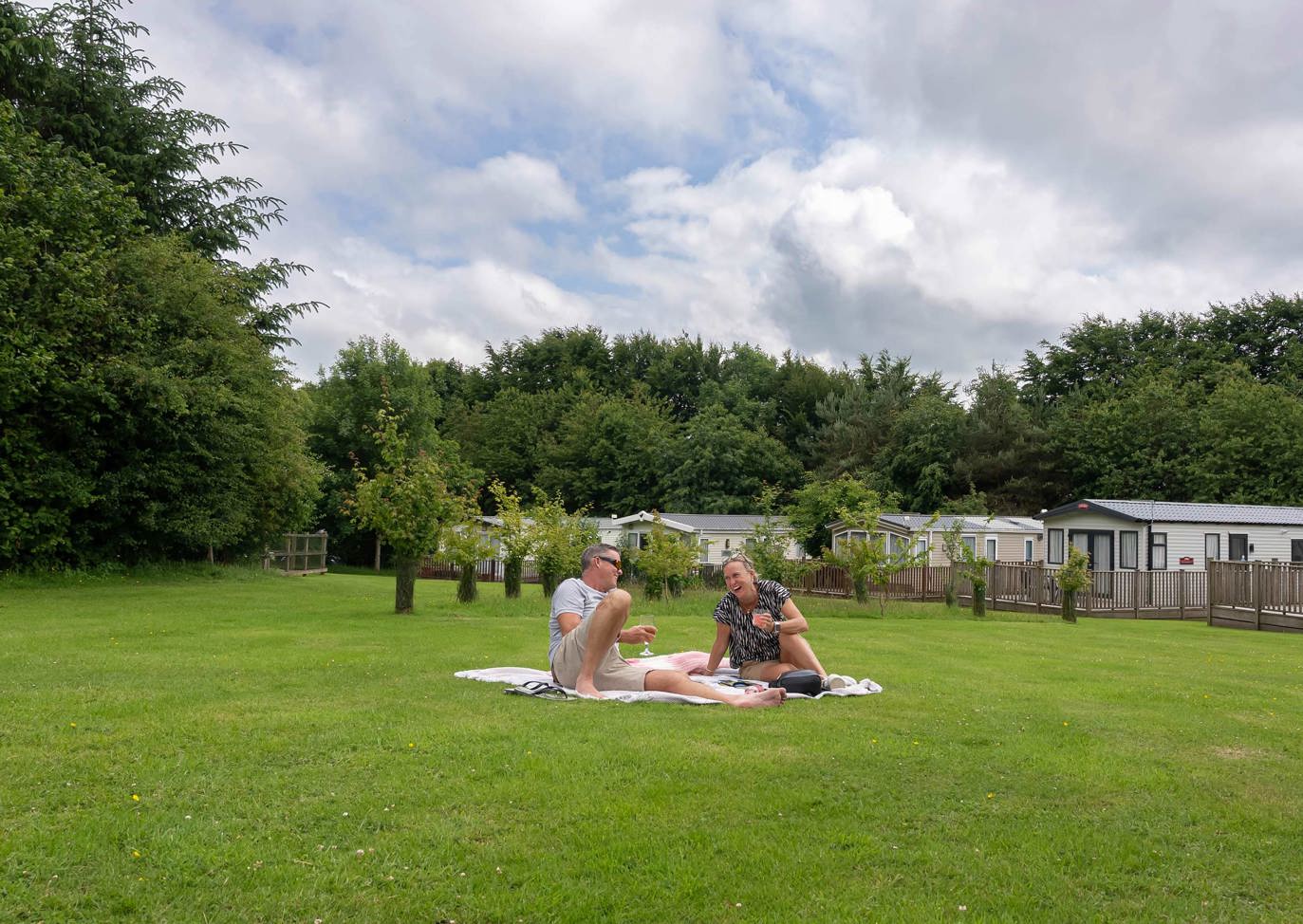 Dartmoor View Couple Laughing On Grass