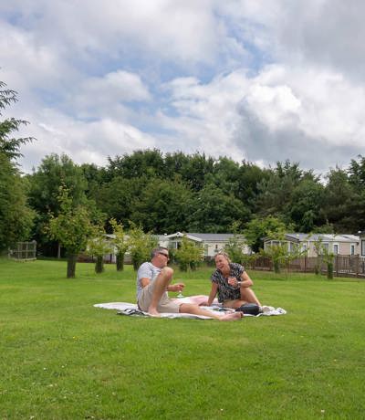 Dartmoor View Couple Laughing On Grass