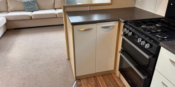 Carnaby Casablanca, cooker in kitchen and sofa in living area at Dartmoor View