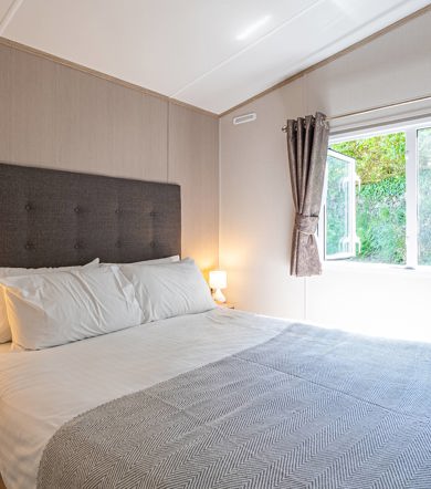 Carnaby Ashdale, master bedroom with open window at Praa Sands