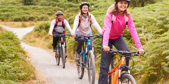 Family cycling around Finlake Holiday park