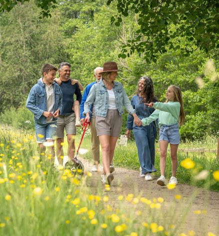 Finlake Family Walking Through Grass