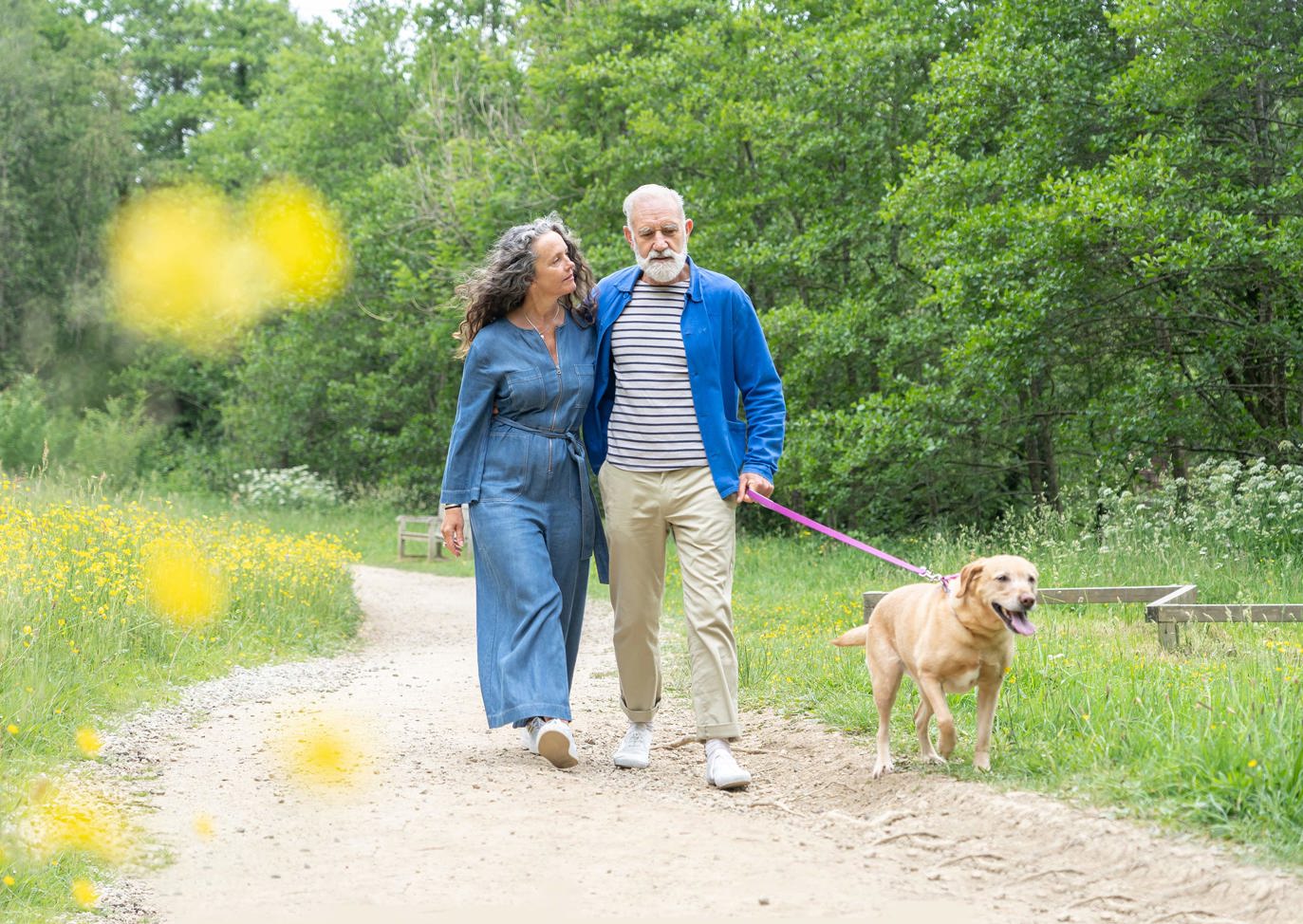 Couple walking their dog in nature