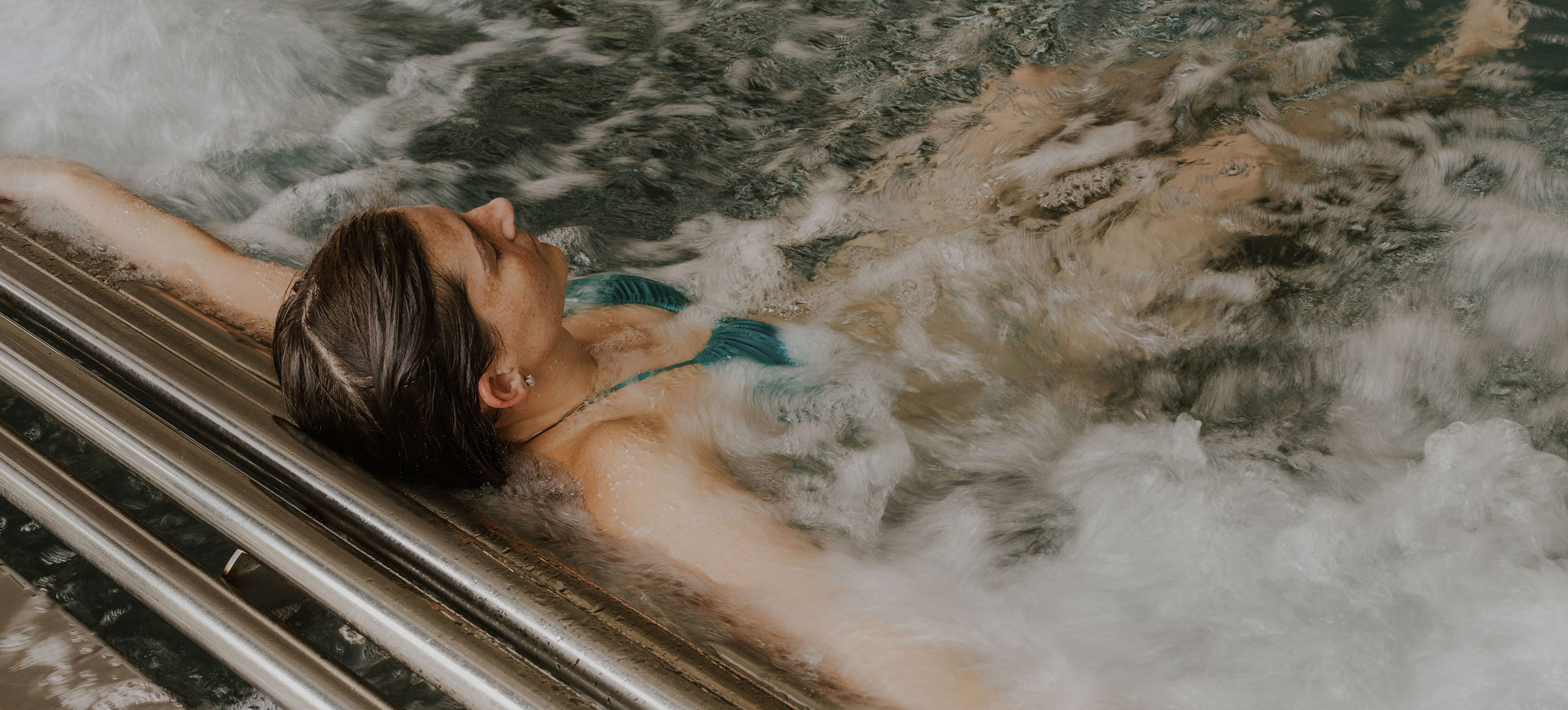 The Warren Lady Floating In Spa Pool Bubbles