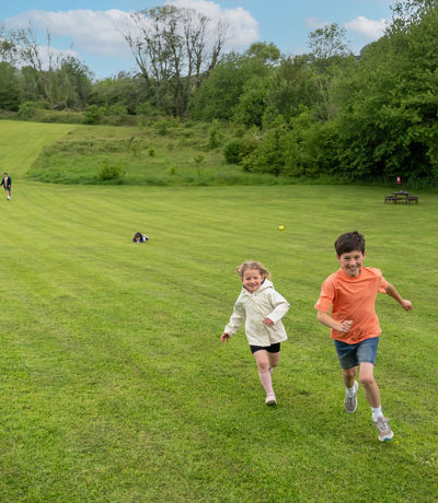 Devon Hills Family Running In The Field