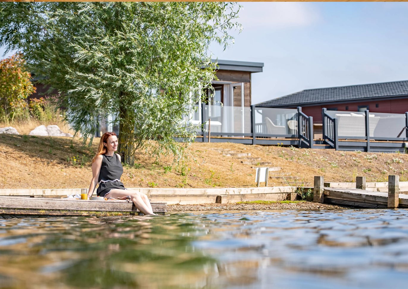 Delamere Lady Sat With Feet Dipped In The Lake