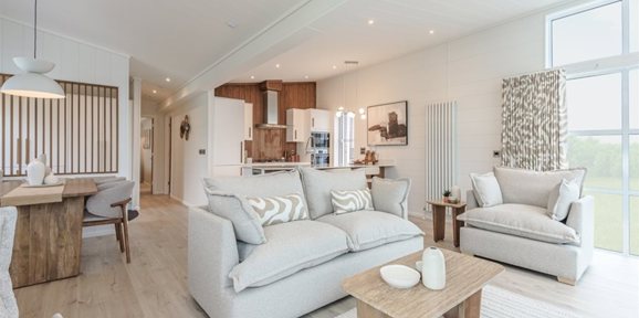 Prestige Aura, living area with sofas at The Warren