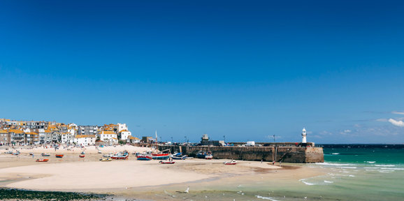 St Ives harbour and beach with boats resting on the sand at low tide near Praa Sand Holiday Park.