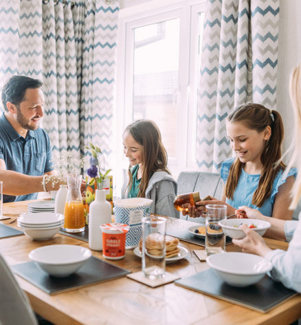 Devon Hills Overview Family Having Breakfast In Lodge