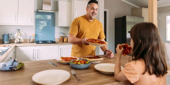 Wessex Contemporary, man serving food in the kitchen at Brokerswood