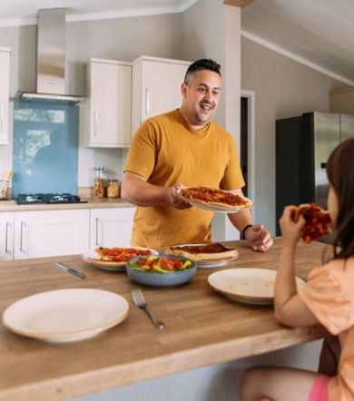 Wessex Contemporary, man serving food in the kitchen at Brokerswood