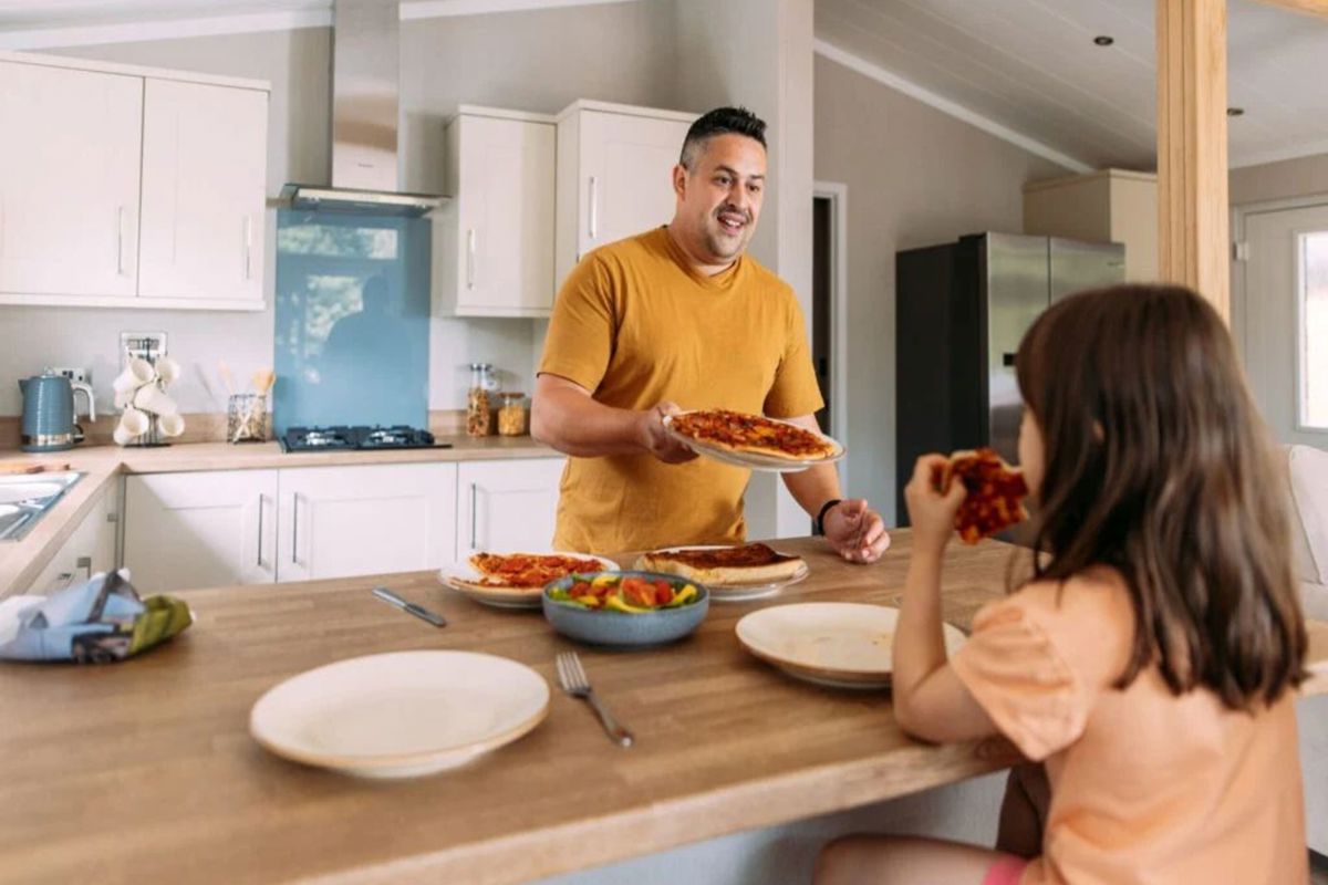 Wessex Contemporary, man serving food in the kitchen at Brokerswood