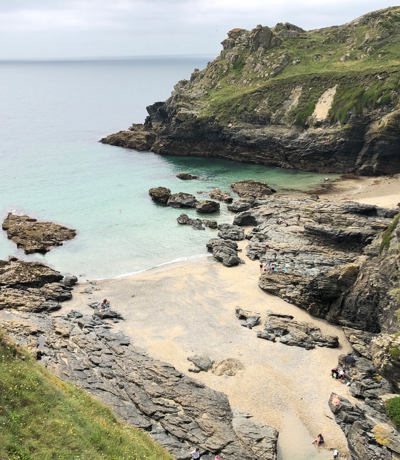 Prussia Cove rocky shoreline and hidden sandy beach with turquoise waters near Praa Sand Holiday Park