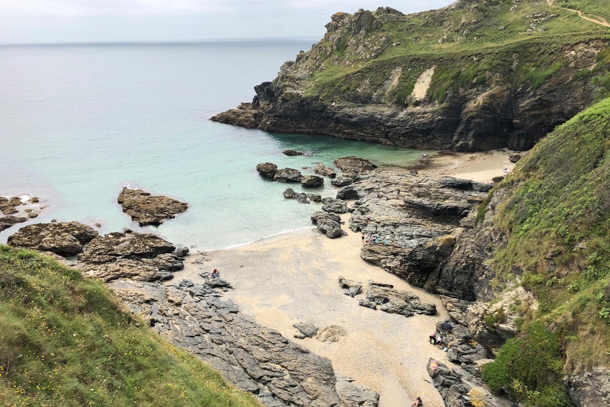 Prussia Cove rocky shoreline and hidden sandy beach with turquoise waters near Praa Sand Holiday Park