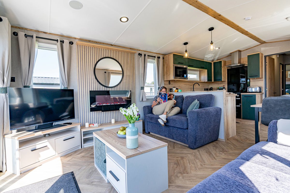 ABI St David, woman reading on the sofa at Praa Sands