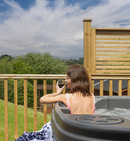 Devon Hills Lady Relaxing With Wine In The Hot Tub