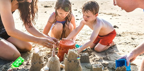 The Warren Local Area Family Playing On The Beach