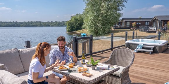 Delamere Couple Eating Pizza Outside Holiday Home