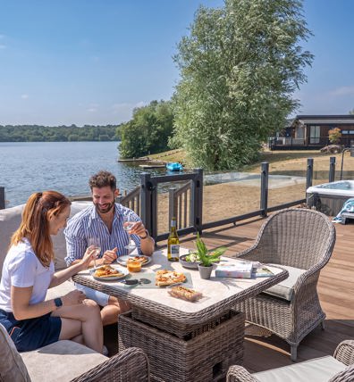 Delamere Couple Eating Pizza Outside Holiday Home