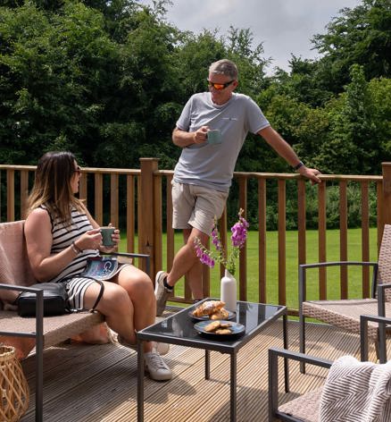 Dartmoor View Couple Talking On Decking