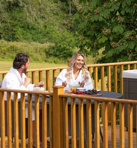 Devon Hills Overview Couple Having Breakfast On Balcony
