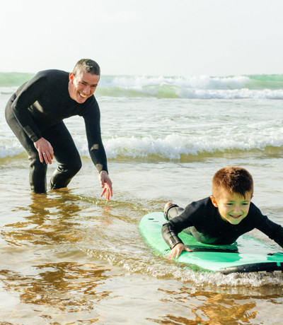 Crugan Local Area Family Surfing In Sea