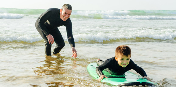 Crugan Local Area Family Surfing In Sea