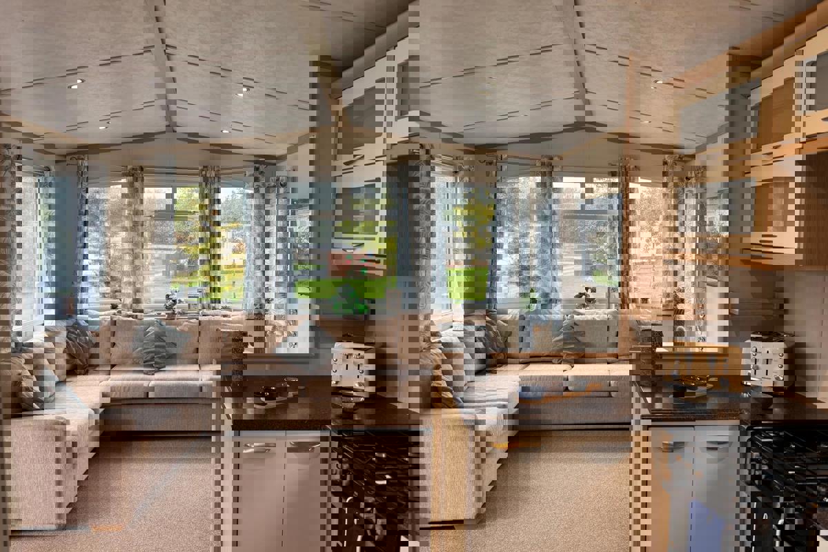 Carnaby Casablanca, windows and corner sofa in living area at Dartmoor View