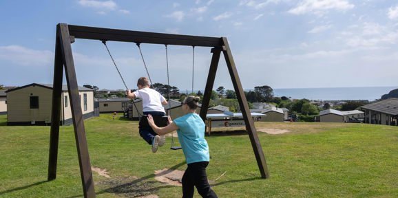 Family Swinging On Swing