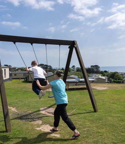Family Swinging On Swing