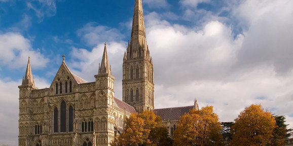 Salisbury Cathedral with its soaring spire and autumn trees in the foreground, Near Brokerswood Holiday Park.