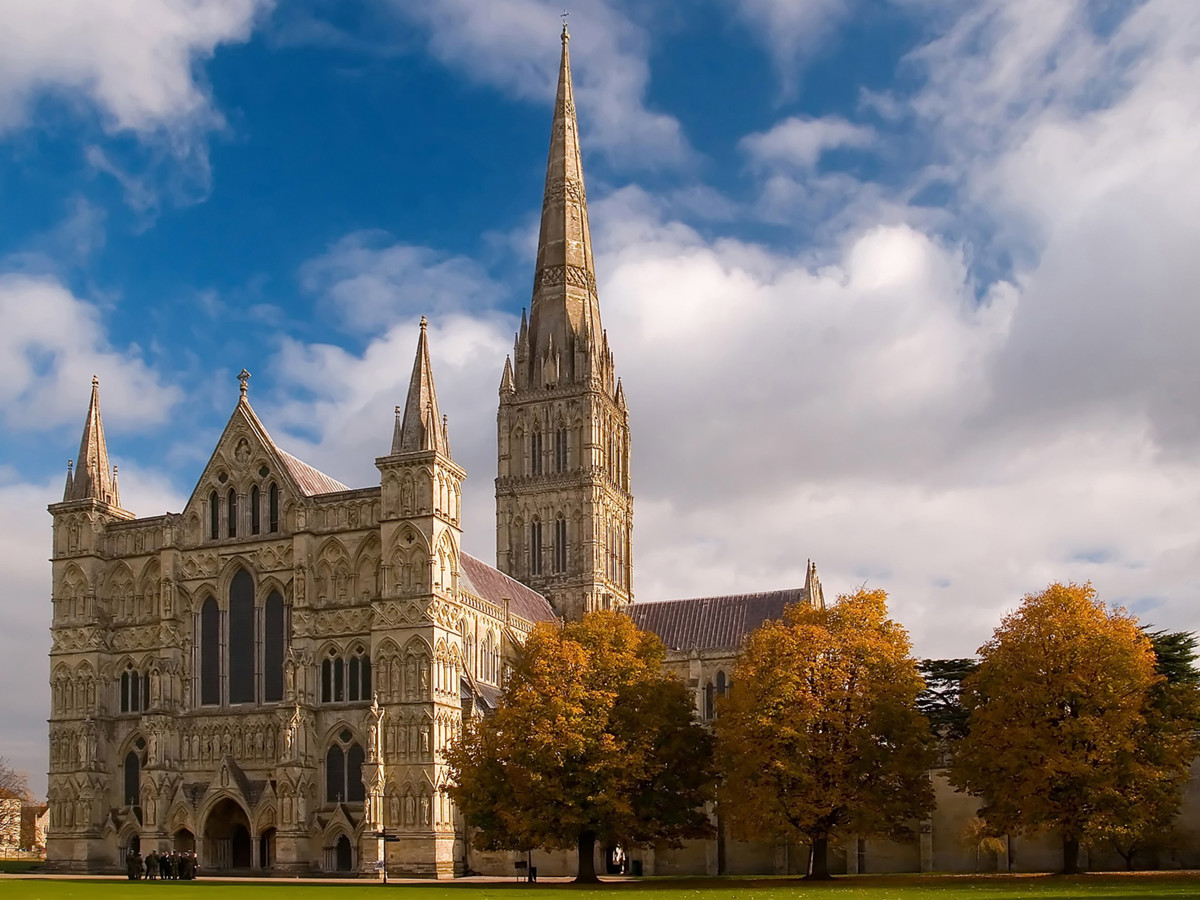 Salisbury Cathedral with its soaring spire and autumn trees in the foreground, Near Brokerswood Holiday Park.