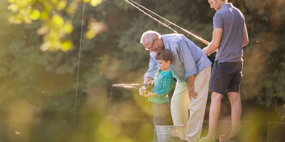 Family fishing at Finlake Holiday Park river