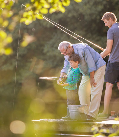 Family fishing at Finlake Holiday Park river