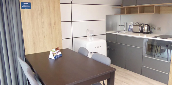 Signature Pod, dining table and kitchen at Finlake