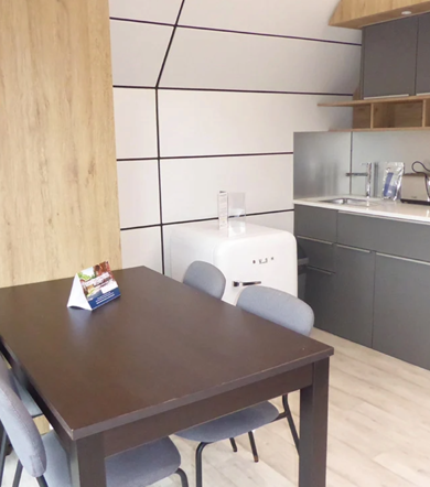 Signature Pod, dining table and kitchen at Finlake