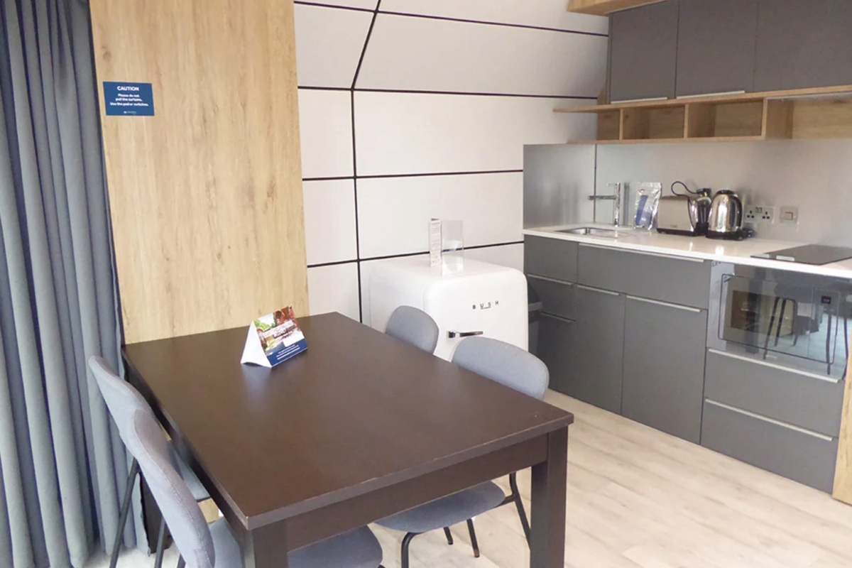 Signature Pod, dining table and kitchen at Finlake