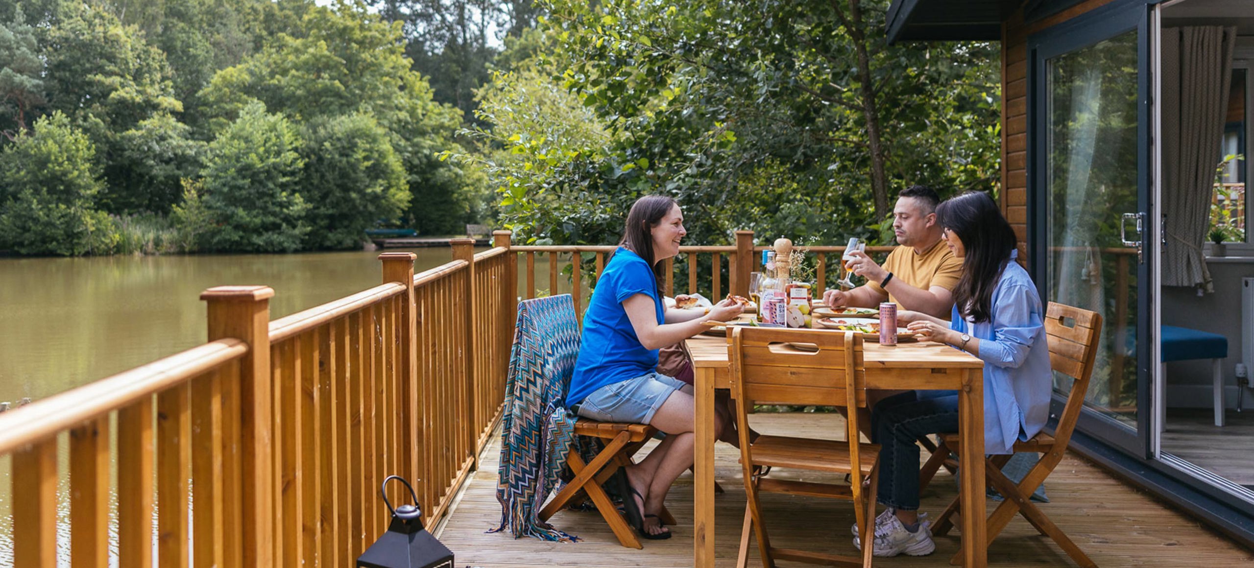 Brokerswood Family Eatingon Decking By Lake