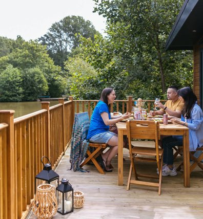Brokerswood Family Eatingon Decking By Lake