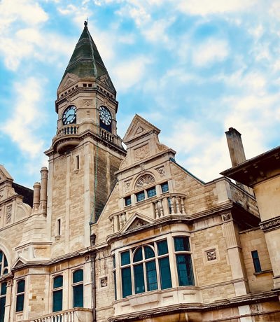 Historic Trowbridge Town Hall with its tall clock tower against a blue sky, Near Brokerswood Holiday Park.