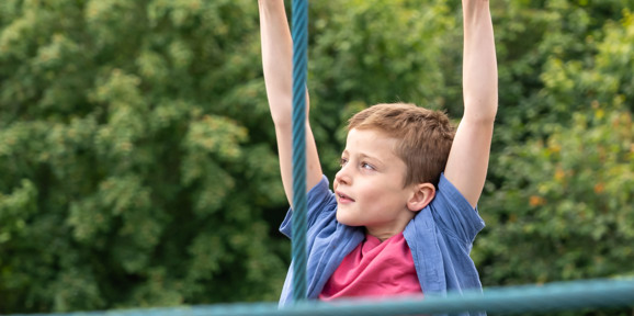 Child on monkey ropes at Dartmoor View play area