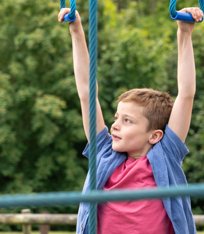Child on monkey ropes at Dartmoor View play area