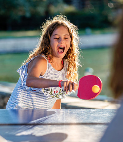 Child playing table tennis at Dartmoor View park