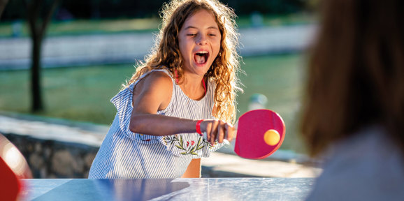 Child playing table tennis at Dartmoor View park