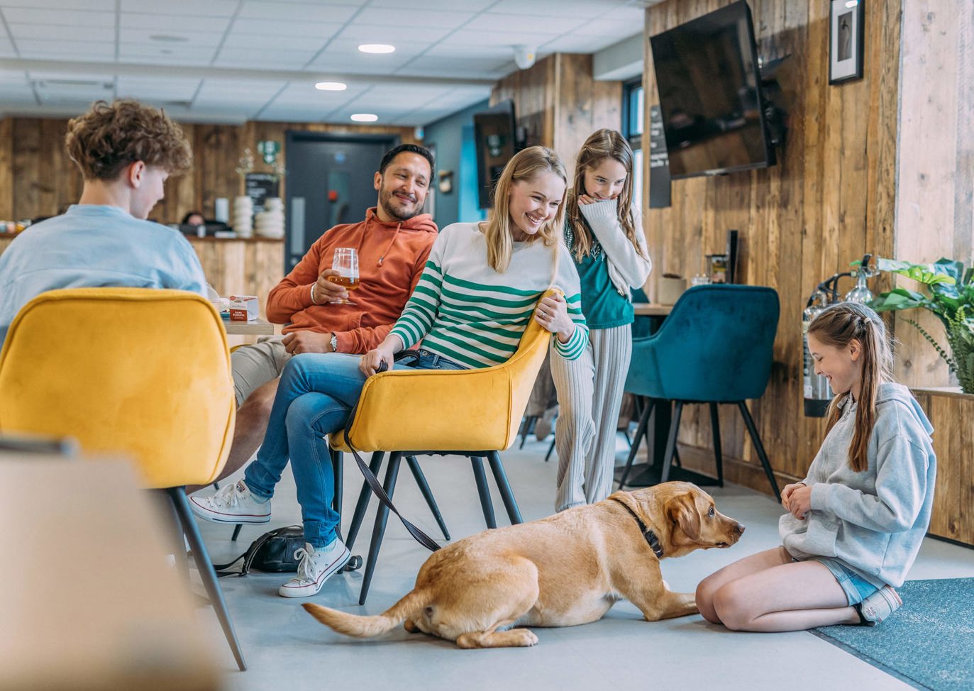 Family with their dog sitting in The Hive at Devon Hills 
