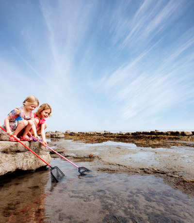 Little girls catching crabs in the sear near Finlake Resort and Spa